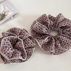 Set of two vintage floral scrunchies with elegant white scalloped edges and dark red petals