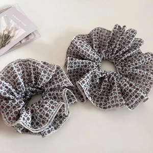 Detail of vintage purple floral scrunchies with delicate ruffled edges and elastic fabric