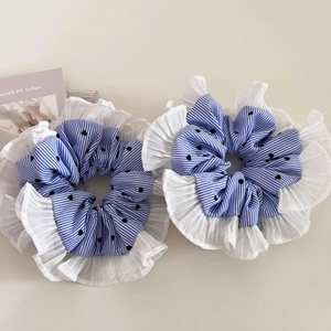 Detail of blue striped scrunchies with black hearts and white pleated lace edges