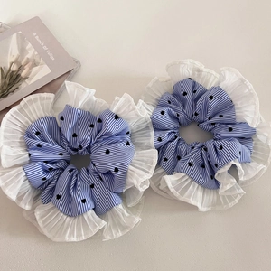 Close-up of blue striped scrunchies with black heart prints and pleated lace edges