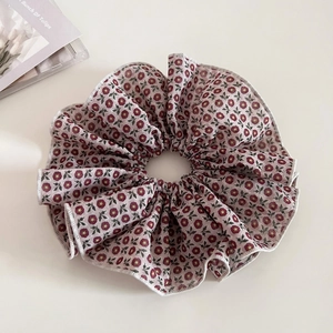 Vintage floral scrunchie with red flower patterns and delicate white ruffled edges
