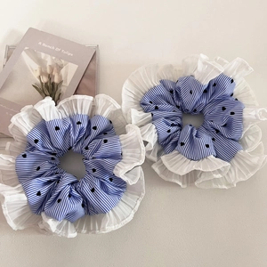 Detail of blue striped hair scrunchies with heart patterns and white lace edges