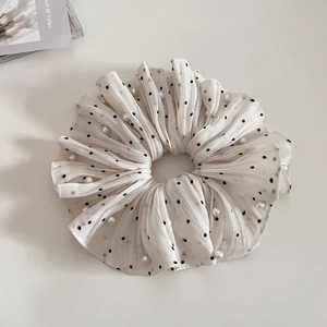 White polka dot scrunchie with pearls and pleated texture for stylish ponytails