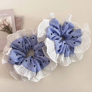 Close-up of blue striped heart pattern scrunchies with white pleated mesh edges