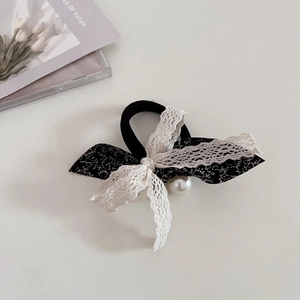 Sweet floral bow hair tie with white lace and double pearl accents on cream background