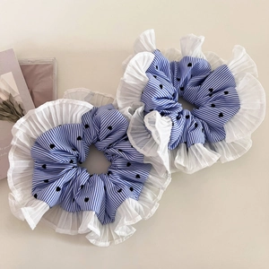 Close-up of blue striped scrunchies with black heart print and pleated chiffon edges