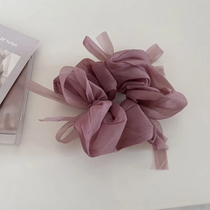Detailed macro view of the dusty rose organza scrunchie with soft pleated texture