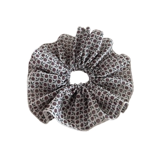 Vintage floral scrunchie in light gray with purple flower patterns and ruffled edges