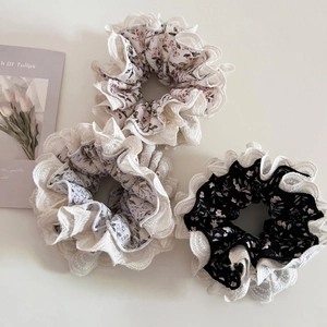 Detailed view of floral hair scrunchies set with double layer lace and rose patterns