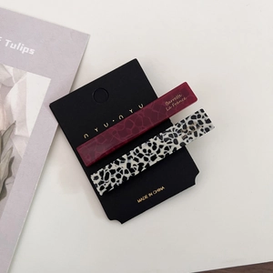 Retro acetate hair clips in tortoise and leopard patterns on display card