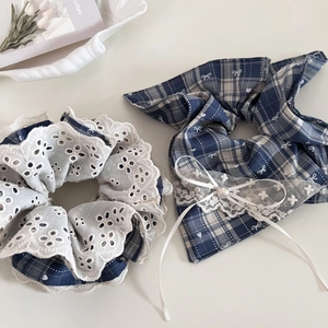 Detail of blue plaid scrunchie and bow hair tie with white lace trim and pearl accent