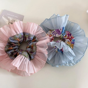 Detail view of large pink and blue organza floral scrunchies with elegant pleats