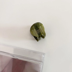 Top view of a mini olive green acetate hair claw clip with golden France Handmade logo