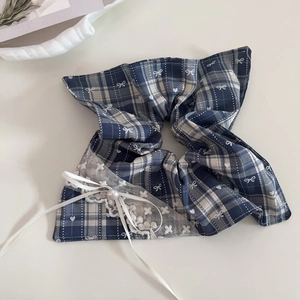 Detailed close-up of blue plaid hair scrunchie with white lace and pearl bow accent