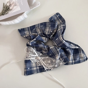 Detailed view of vintage blue plaid scrunchie with white lace trim and pearl bow detail