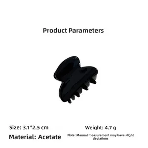 Detail view of mini acetate hair claw clip showing size 3.1x2.5cm and shiny black texture