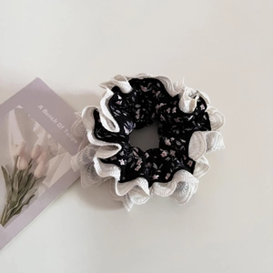 Detail of floral lace hair scrunchie with pink flowers and white lace trim