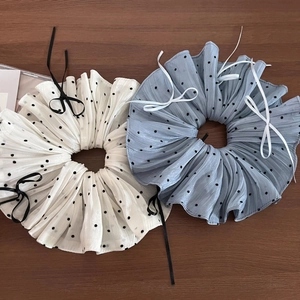 Detail of soft chiffon scrunchies with polka dot pattern and elegant ribbon bows