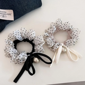 Close-up of polka dot chiffon scrunchies with bows and silver metallic beads