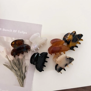 Detailed set of six retro acetate hair claws in assorted colors and marble textures