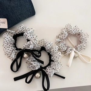 Detail of polka dot chiffon scrunchies featuring elegant ribbons and pearl charms
