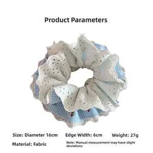 Detail of blue plaid lace scrunchie with cherry embroidery, measuring 16cm in diameter