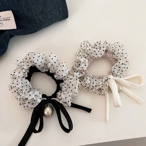 Close-up of mesh polka dot scrunchies with velvet bow and pearl charms for hair