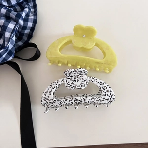 Elegant floral acetate hair claws in yellow and marble pattern with rhinestone centers