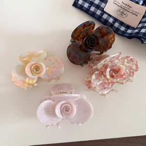 Detail of French acetate rose hair claws in tortoise shell and marble patterns