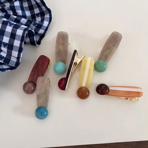 Detail view of retro acrylic duckbill hair clips with colorful geometric resin patterns