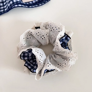 Navy blue gingham scrunchie with delicate white lace embroidery and vintage bow design