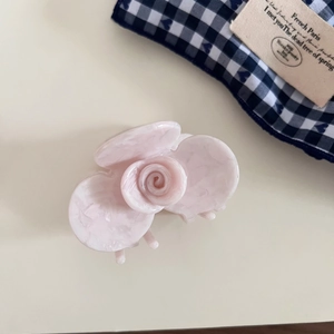 Detail view of pink orchid acetate hair claw clip with marble texture for half-up hairstyles