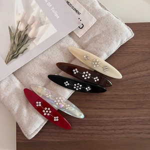 Five-piece acetate hair clip set with sparkling rhinestone floral patterns and polished finish