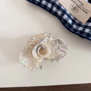 Detail showing the elegant marble texture on a French rose shaped acetate hair claw clip