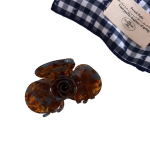 French retro acetate rose hair claw clip with tortoise shell pattern on white background