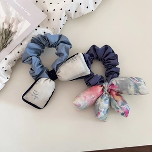 Detail of floral ink painting bow hair scrunchies with soft padded fabric texture