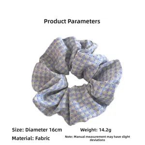 Detail view of blue plaid hair scrunchie showing 16cm diameter and fabric texture
