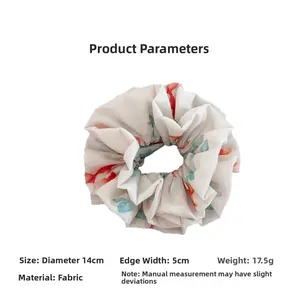 Detail view of ink painting goldfish fabric scrunchie measuring 14cm in diameter