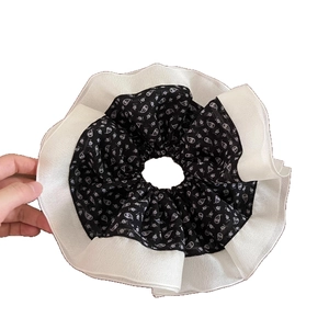 Floral paisley scrunchie for women featuring black and white double-layered ruffled fabric