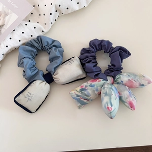 Detail of blue and purple floral scrunchies with padded bows in artistic oil painting style