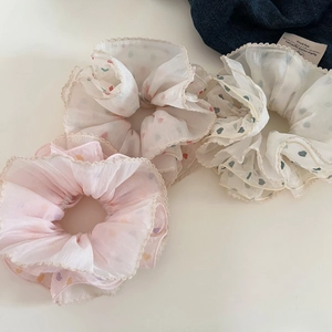 Detailed view of three heart pattern chiffon scrunchies with elegant lace trim edges