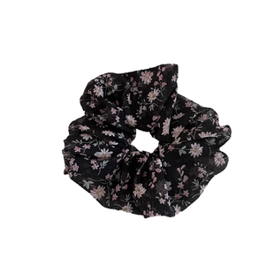 Elegant black chiffon floral scrunchie with pink daisy patterns for ponytail styling