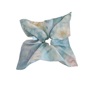Elegant light blue floral silk scrunchie with a large bow design and artistic ink patterns