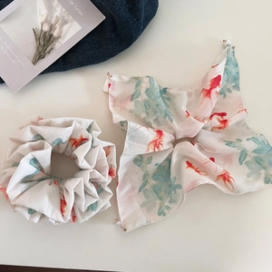 Detail of red goldfish pattern on silk hair scrunchie and ribbon with pearl accents