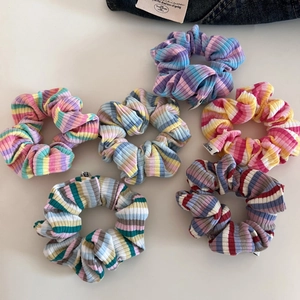 Set of colorful striped ribbed knit hair scrunchies in vibrant rainbow palette