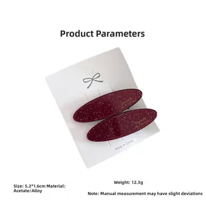 Detail showing deep burgundy acetate oval hair clips with dimensions 5.2x1.6cm and weight 12.3g