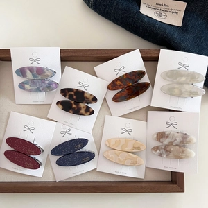 Detail of assorted vintage oval acetate hair clips in various marble and tortoiseshell patterns
