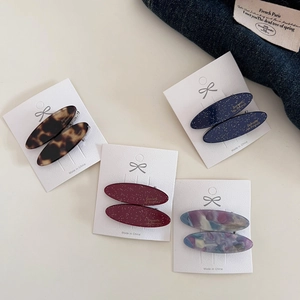 Detailed set of four oval acetate hair barrettes in tortoiseshell and marble patterns