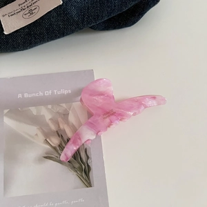 Close-up of pink marble acetate hair claw clip with France Handmade lettering details