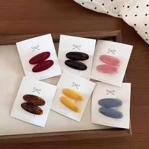 Vintage oval acetate hair clips in six colors on white card display, French style set